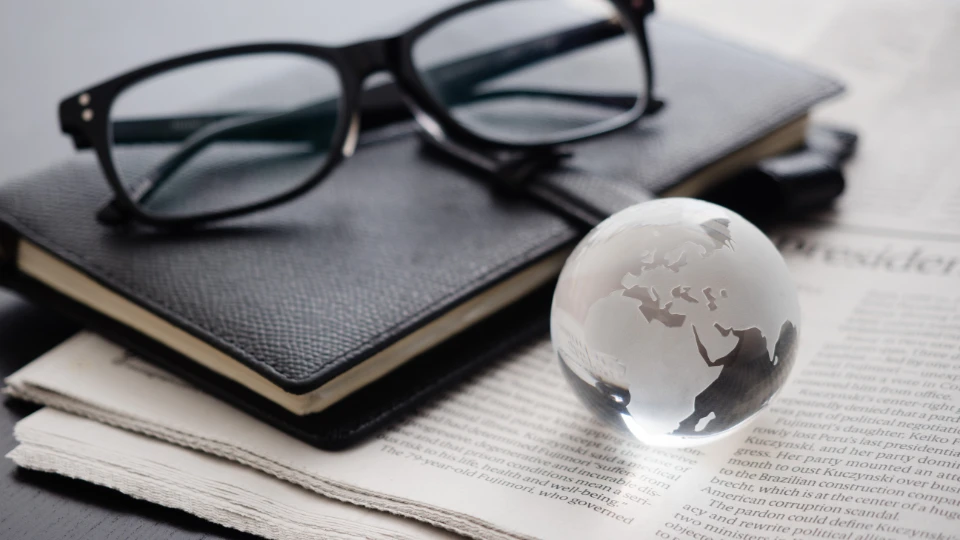 Main findings from Nordic studies combining PIAAC and other data sources A transparent glass globe with etched outlines of continents, sitting on a newspaper.